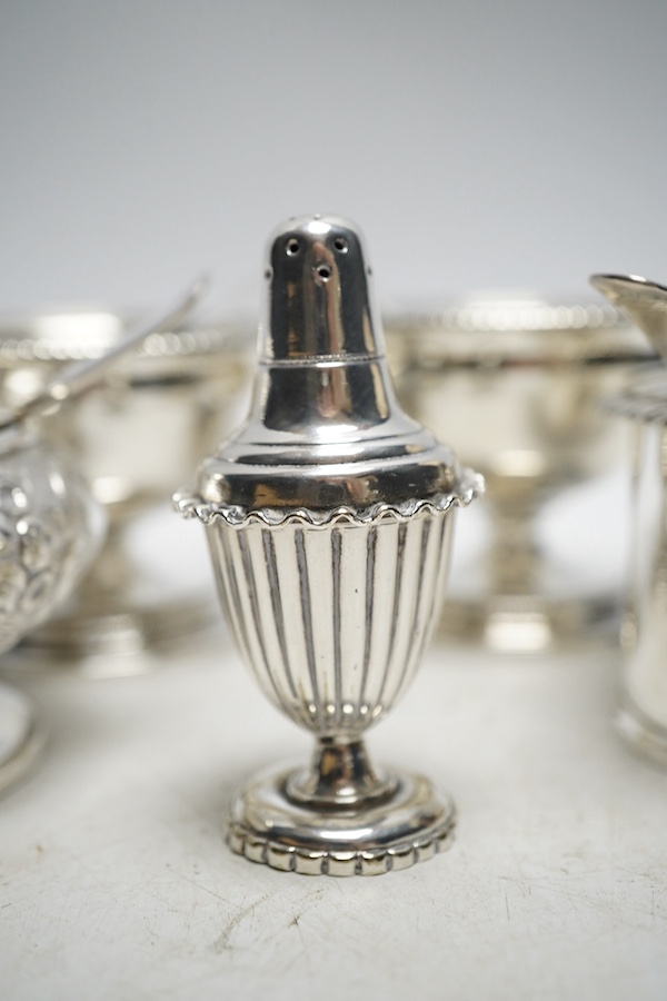 A pair of George III silver salts, London 1799, 240g, a George IV silver mustard pot, London 1822, 116g, a Victorian silver drum mustard pot, by Edward John and William Barnard, London 1850, four various mustard ladles (